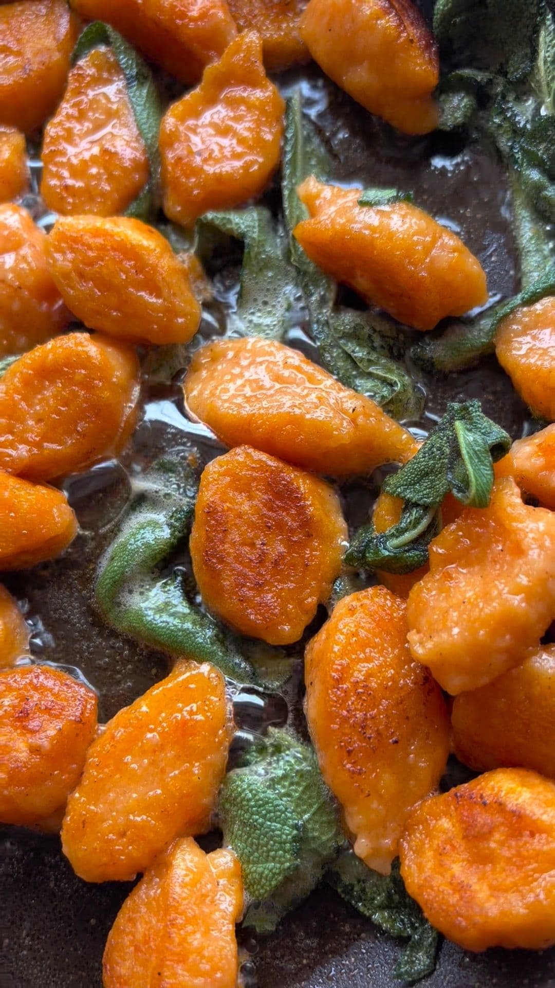 Sweet potato gnocchi plated with sage and parmesan