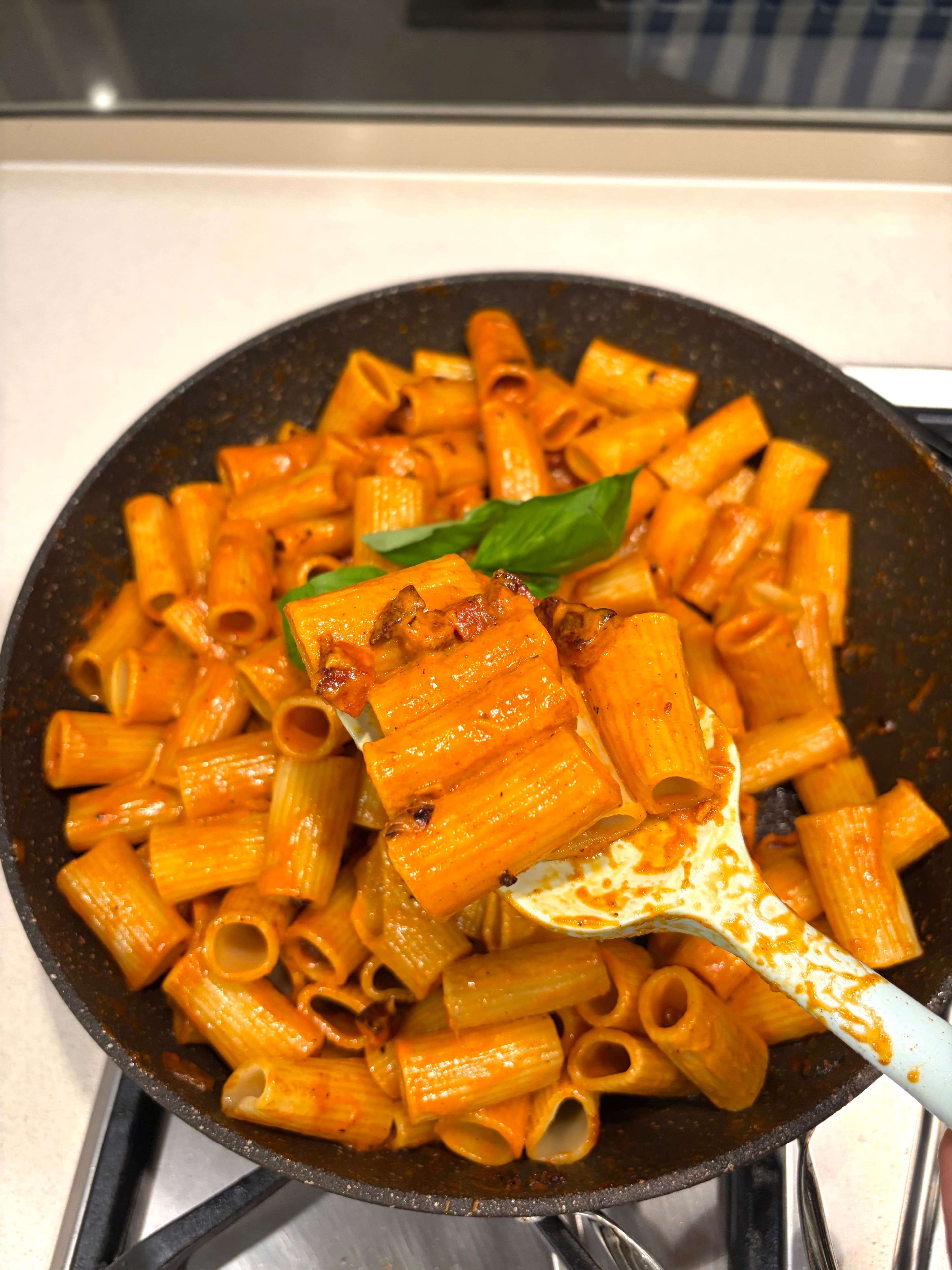 Vodka pasta in a bowl with parmesan and basil