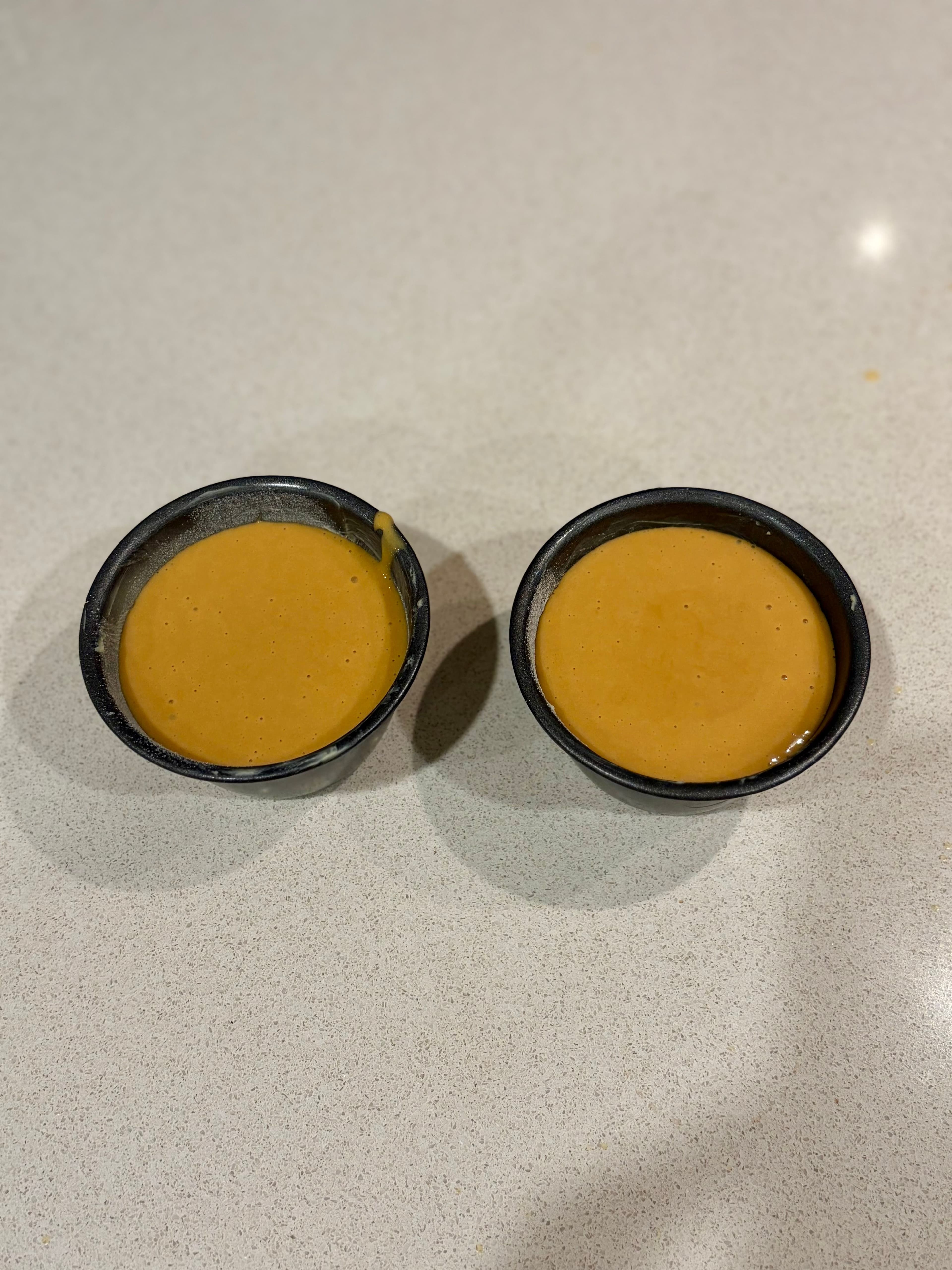 Ramekins filled with dulce de leche batter
