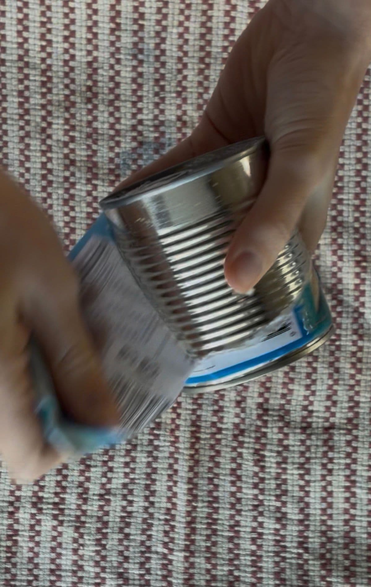 Peeling the label off the can