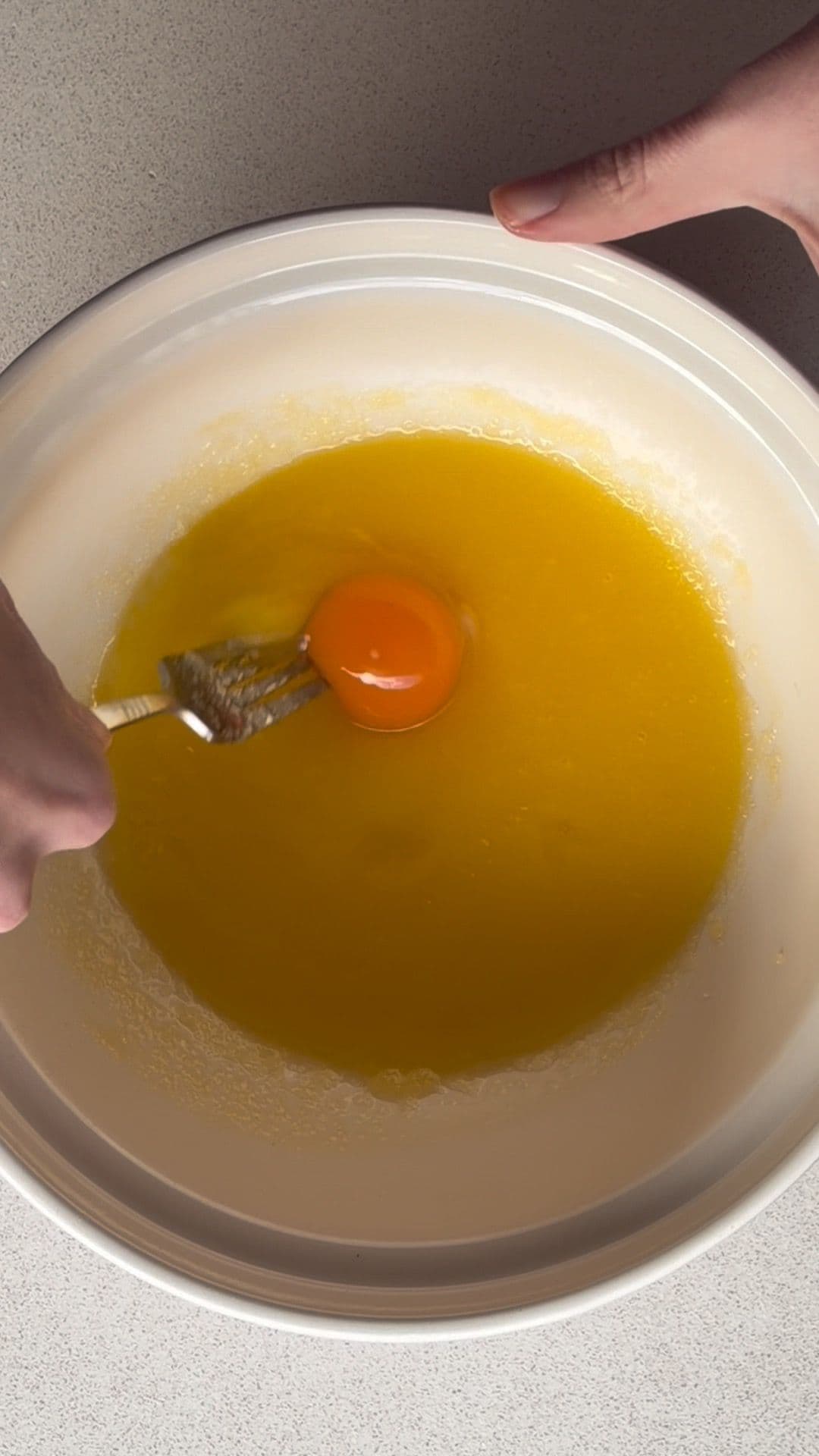 Whisking egg into butter and sugar mixture