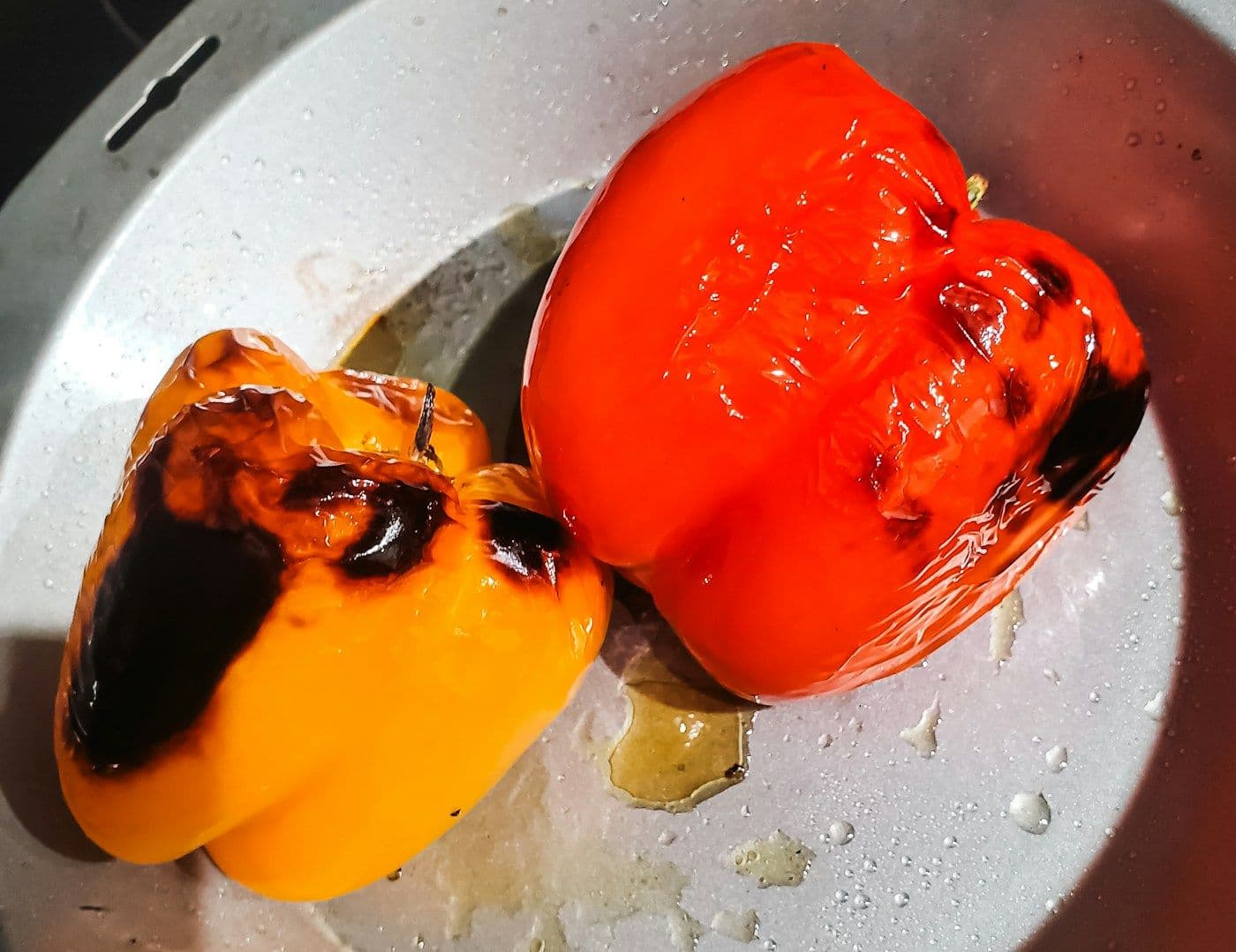 Roasted red capsicums charred over a flame
