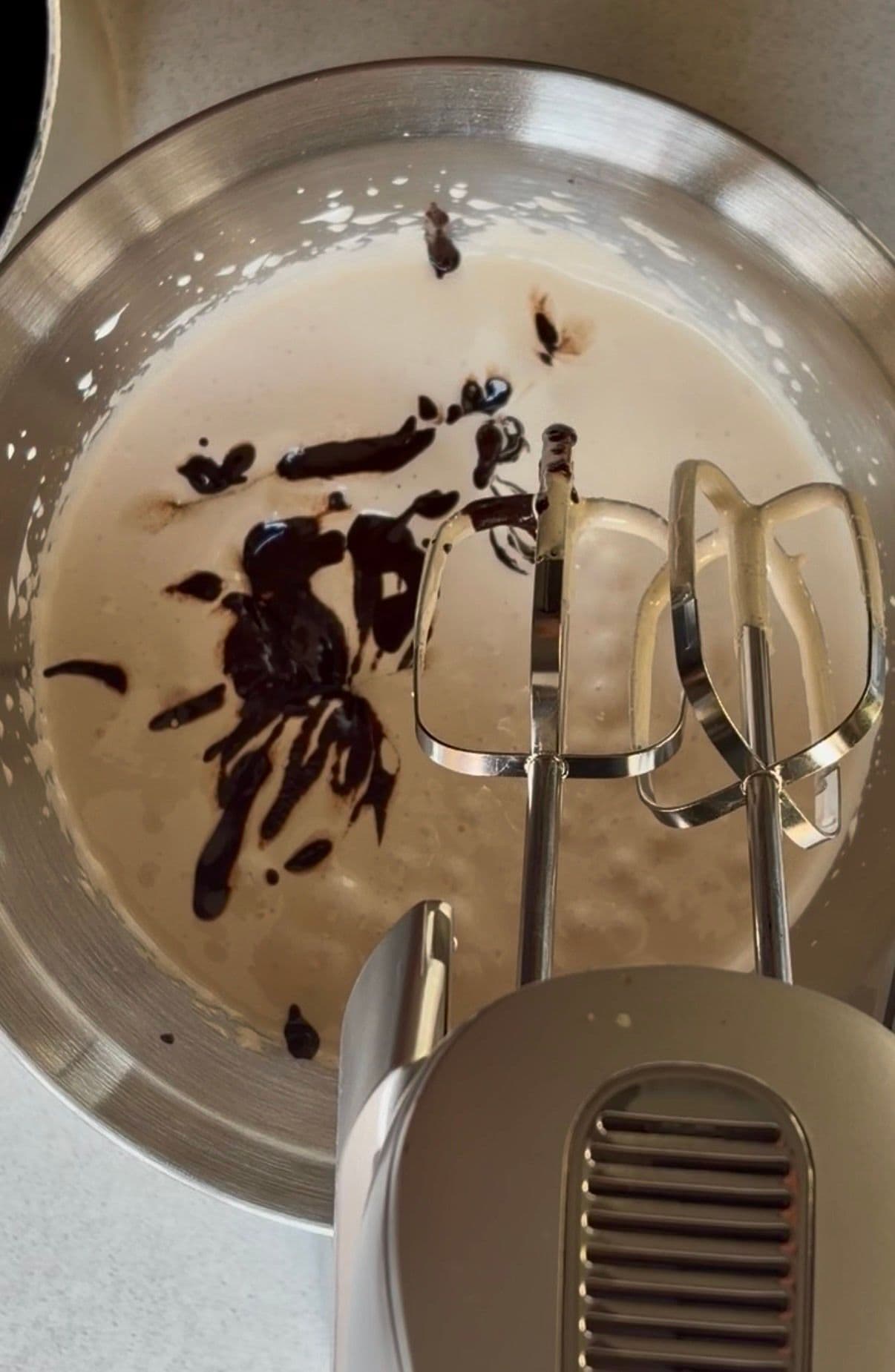 Melted chocolate being mixed into the yolks
