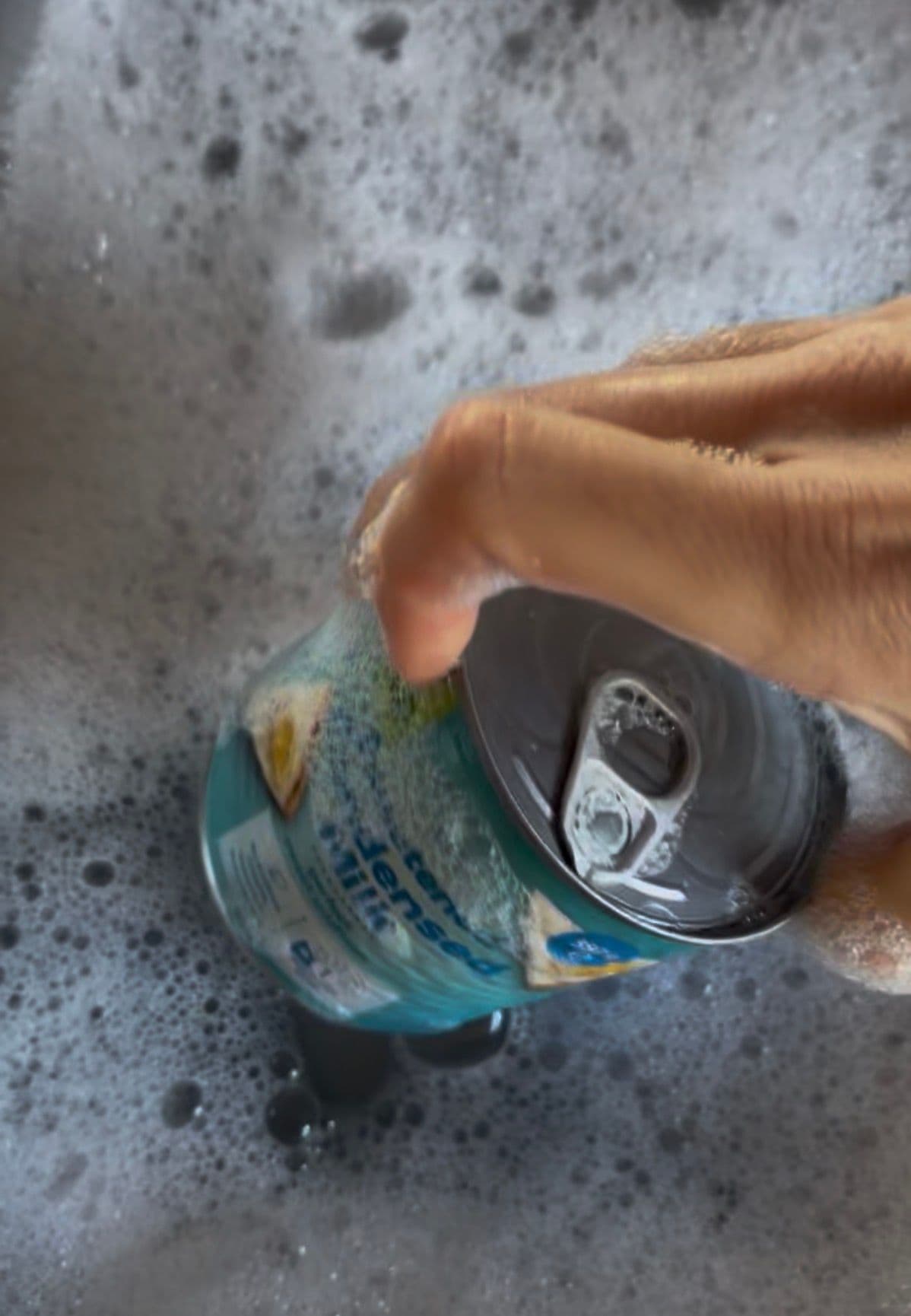 Soaking can in warm soapy water