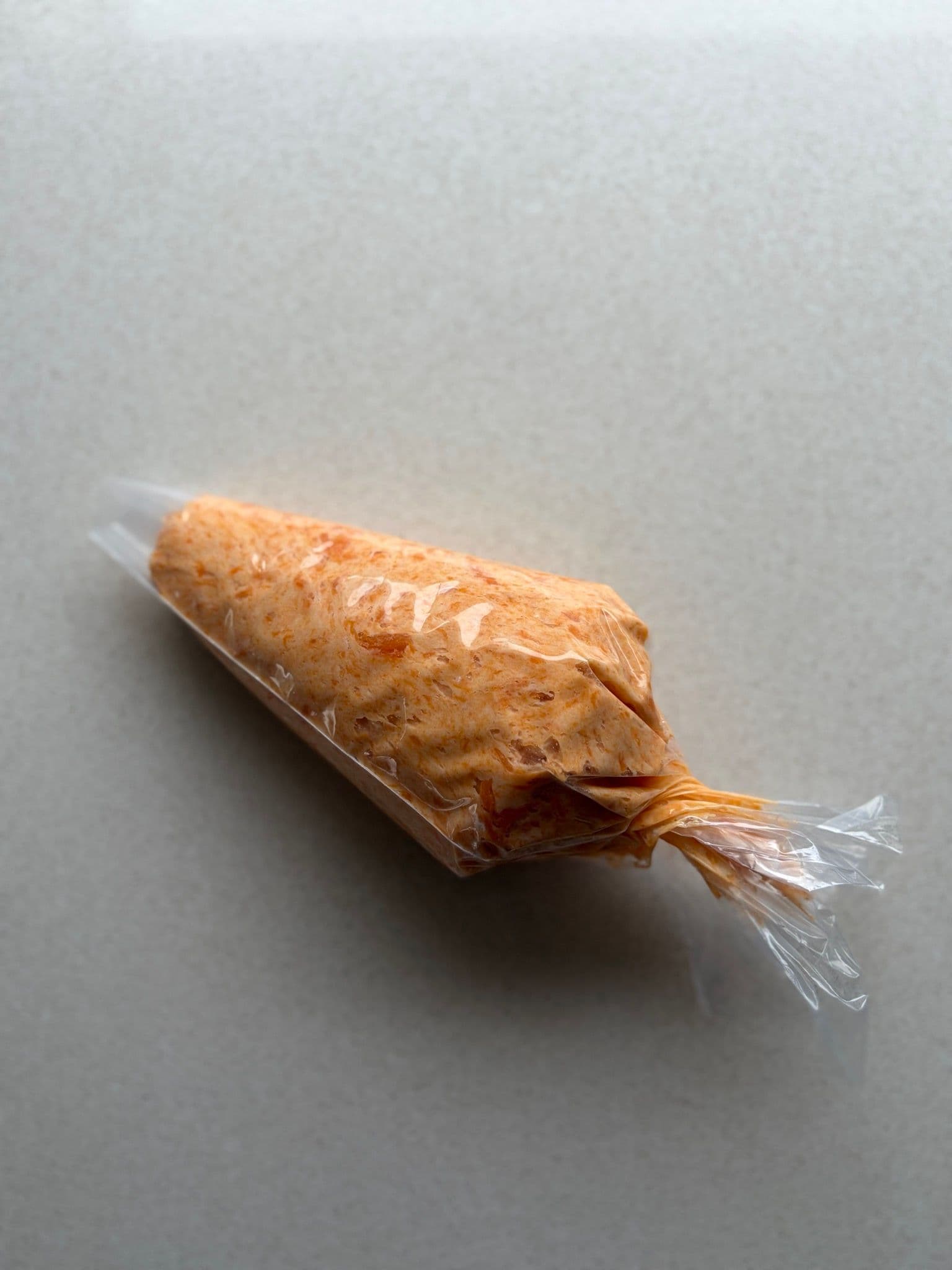 Piping bag filled with sweet potato gnocchi dough, ready to go