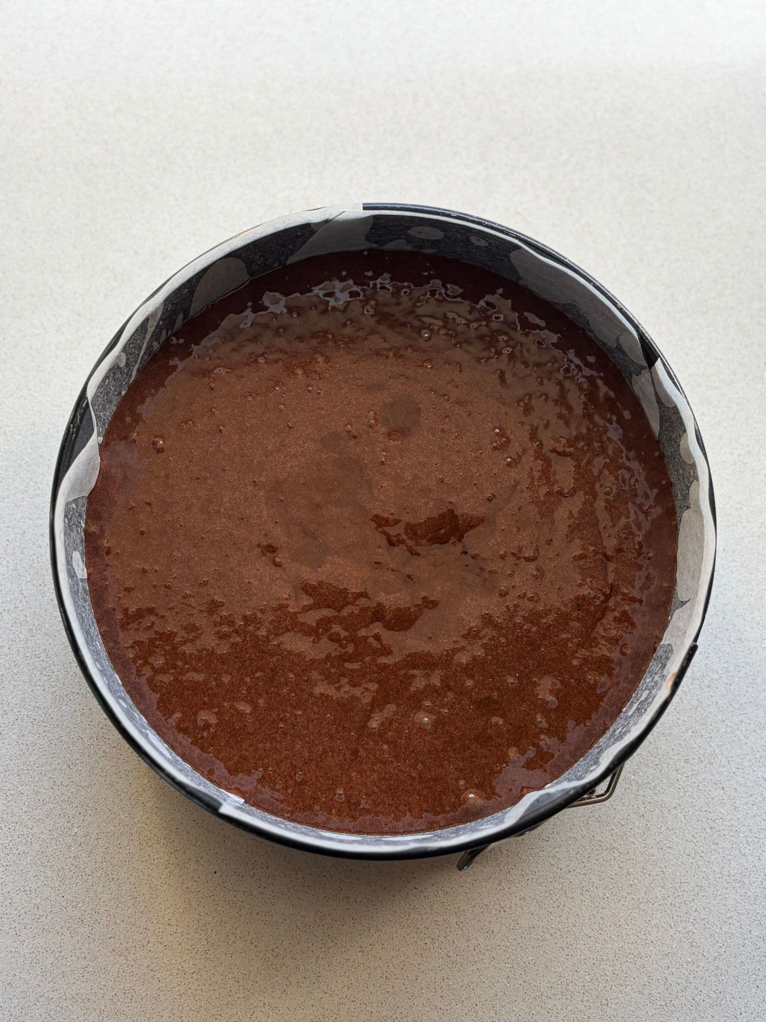 The batter poured into the cake tin