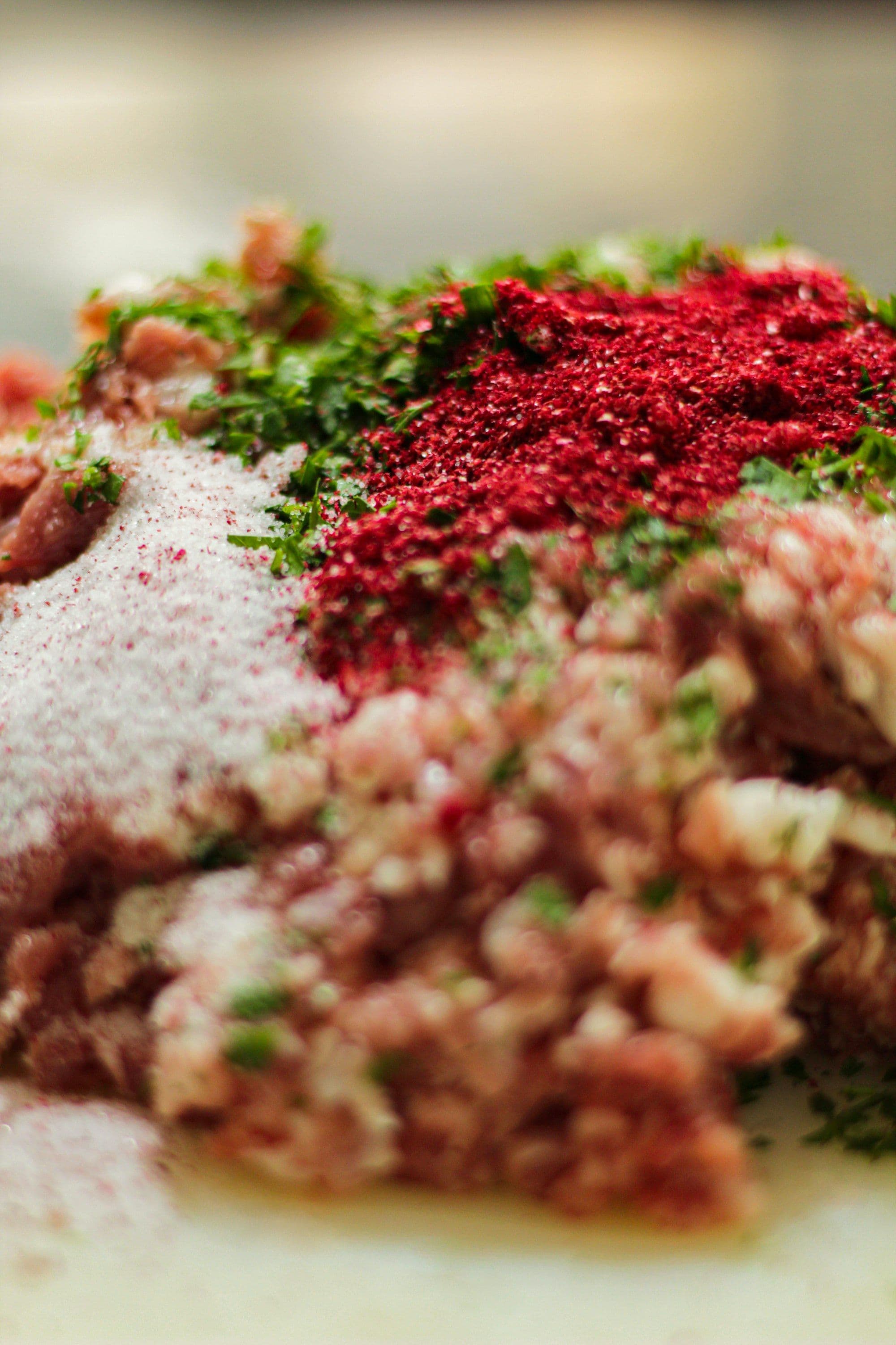 Raw lamb mince with spices and herbs ready to be mixed