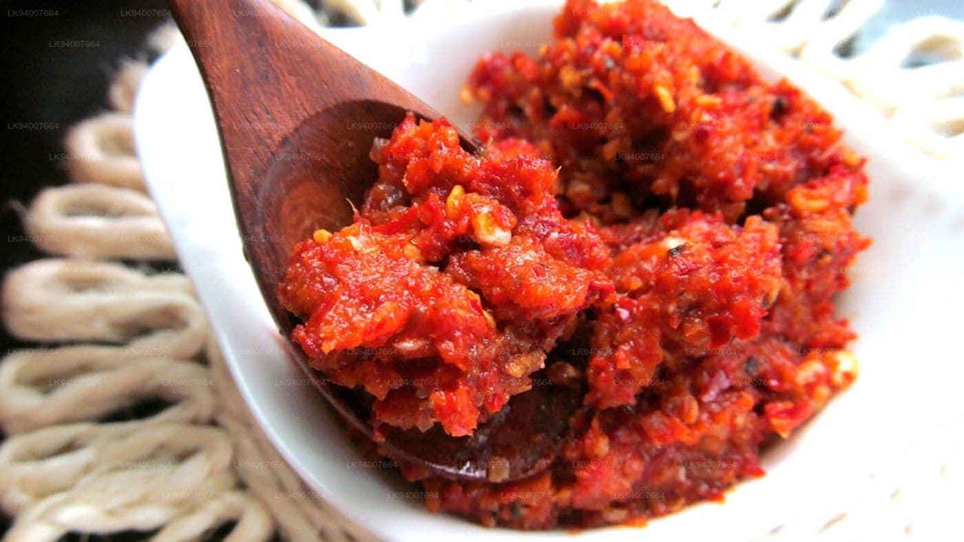 Harissa paste being scooped with a wooden spoon
