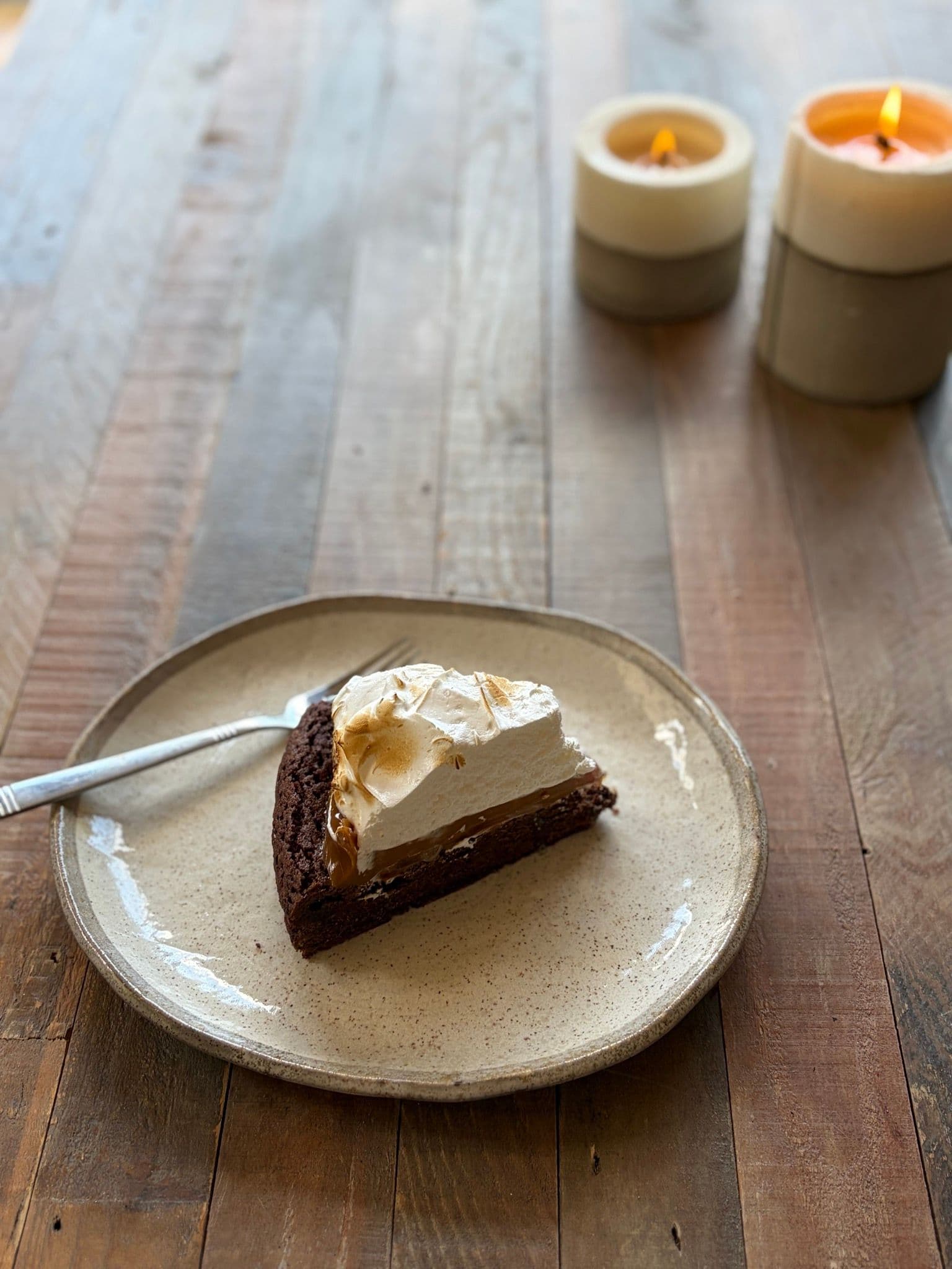 A slice of marquise showing the brownie base, dulce de leche and meringue layers