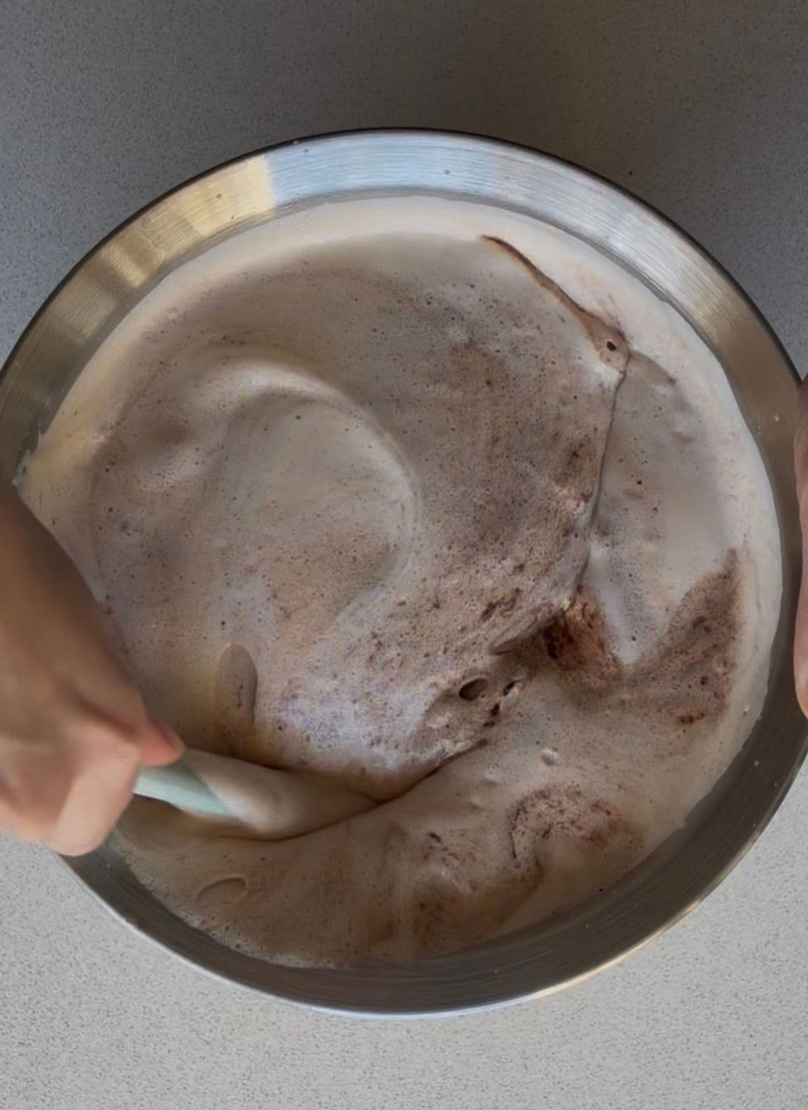 Folding the chocolate into the beaten eggs