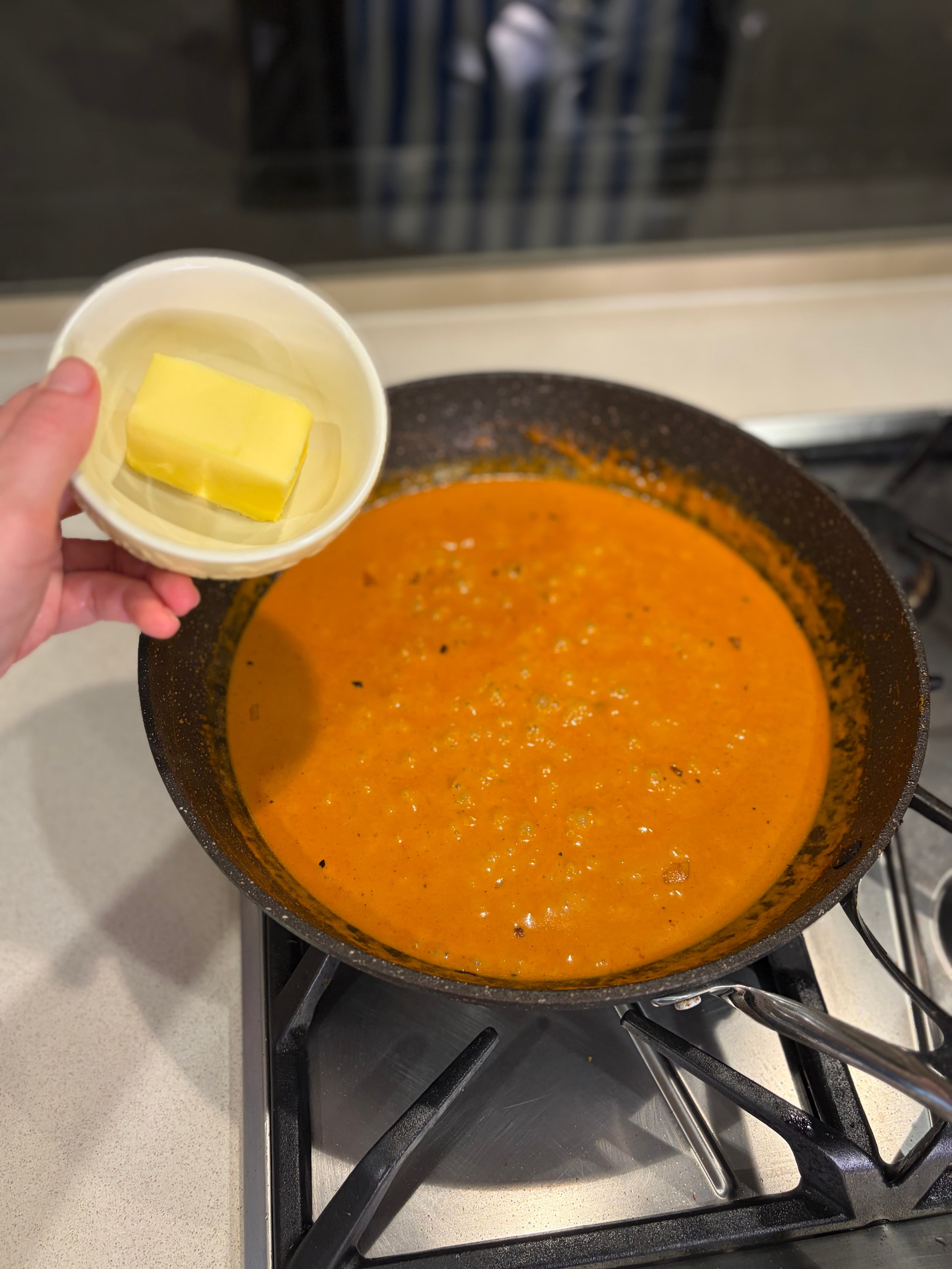 Stirring in butter to finish the sauce