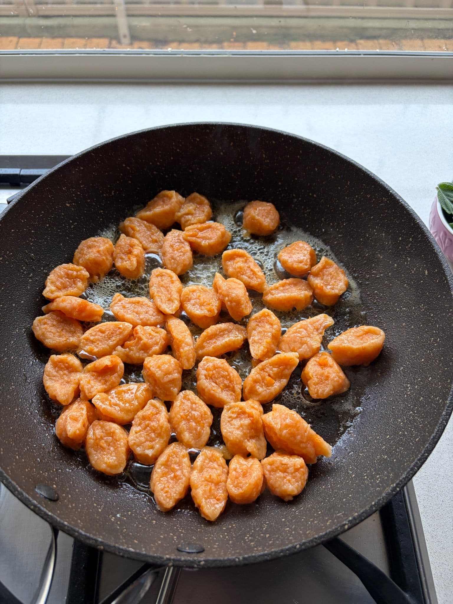 Gnocchi frying in the pan before adding butter and sage