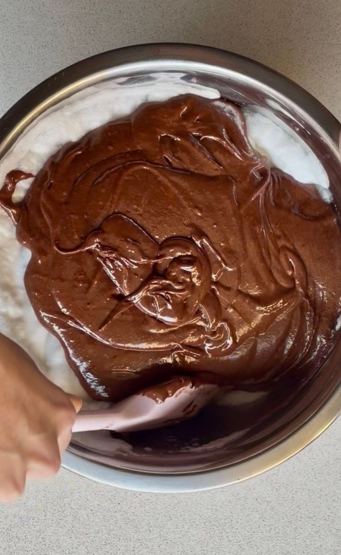 Folding the chocolate mixture into the beaten egg whites