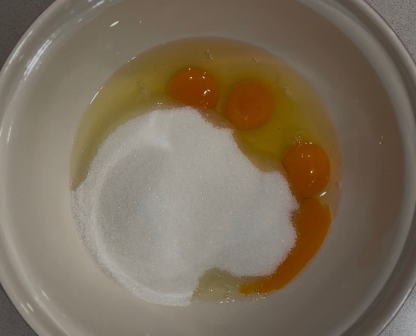 Eggs and sugar in the bowl before whipping